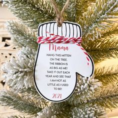 a christmas ornament hanging from a tree with the words mama written on it