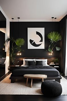 a black and white bedroom with plants on the wall above the bed, along with an ottoman