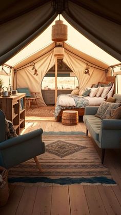 the inside of a tent with two couches and a bed in it's center