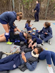 a group of people sitting on the ground together