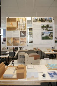 an office area with desks, chairs and pictures on the wall