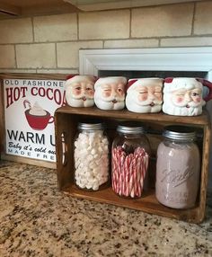 several jars filled with candy canes and santa clause faces on top of a shelf