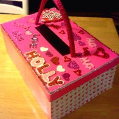 a pink box sitting on top of a wooden table