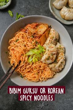 a white bowl filled with noodles and chicken on top of a gray table next to other dishes