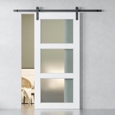 an open white door with frosted glass on the inside and side panels in between