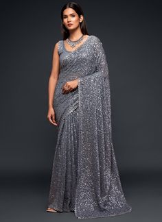 Dominate any party or event with this premium grey sequins and thread designer saree. Made with luxurious georgette fabric, it will make you stand out from the crowd. Perfect for receptions and festive occasions, it also makes a great gift for your girlfriend. Take on the challenge and embrace the adventure of looking stunning and confident! The unstitched blouse can be customized upto 42 inches. Do Note: All the accessories shown are for styling purpose only. Slight color variation may occur du Sequins Saree, Sequence Saree, Sequin Saree, Grey Saree, Party Sarees, Red Lehenga, Party Wear Saree, Patiala Salwar, Party Kleidung