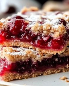 two pieces of berry crumb bars stacked on top of each other