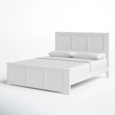 a white bed with two pillows on top of the headboard and foot board is shown in front of a plain background