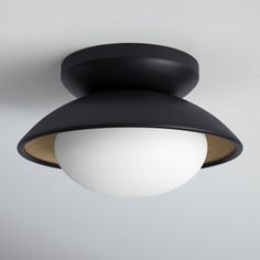 a black and white light hanging from the ceiling