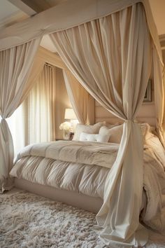 a large bed with white sheets and curtains on it's headboard in a bedroom