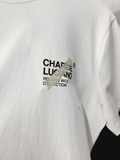 a white t - shirt with the words charine lucano on it's chest