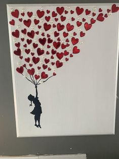 a painting with hearts on it and a person holding a balloon in the shape of a heart