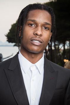 a young man with dreadlocks wearing a suit