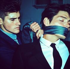 two men with ties tied to their mouths