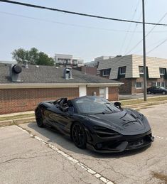 a black sports car is parked on the street