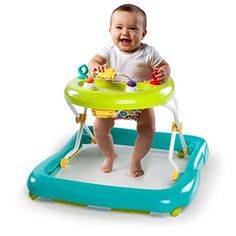 a baby sitting in a high chair playing with toys