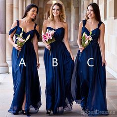 three women in blue dresses standing next to each other and one is wearing a flower bouquet