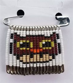 the beaded purse is decorated with multicolored beads and silver metal clasps