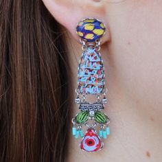 Feeling blue has never looked this good! The Carnival Dalia Earrings use multiple materials like European crystal, Czech glass beads, and other textiles. With hues of blue and red with accents of green and yellow, these earrings are sure to liven up your ensemble and your mood. The round post is linked on both sides to an elongated oval that has a lively print. Linked to that section are an assortment of baubles and charms varying in shapes and colors. You are sure to have a blast styling these Hues Of Blue, Elongated Oval, Bar Jewelry, The Carnival, Feeling Blue, Green And Yellow, Having A Blast, Caicos Islands, Pitcairn Islands