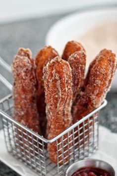 a basket filled with fried food sitting on top of a table