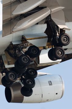 the underside of an airplane with wheels attached to it's cargo compartment and landing gear