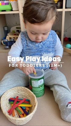 a little boy sitting on the floor playing with some sort of plastic letters and building blocks