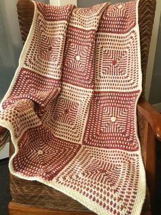 a red and white blanket sitting on top of a chair