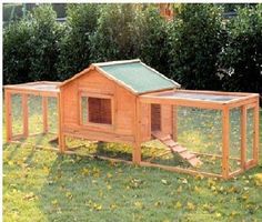 a small wooden chicken coop in the grass