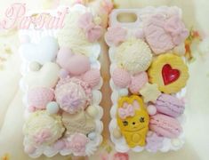 two cell phones are decorated with teddy bears and other items in pastel pinks