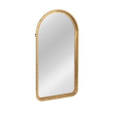 a gold framed mirror sitting on top of a white wall