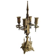 an old fashioned chandelier with candles on it's sides and ornate designs