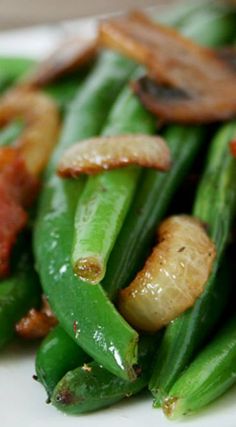 green beans and bacon are on a white plate