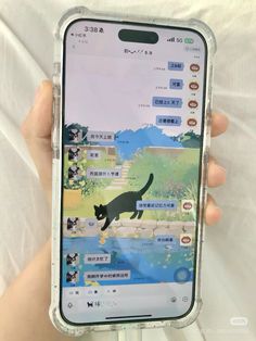 someone is holding up their phone with an image of a cat in the water on it