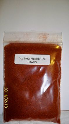 a bag of powdered red chili sitting on top of a white countertop next to a wall