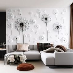 a living room with white furniture and large dandelions on the wall