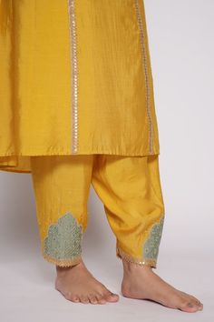 Yellow chanderi kurta with embroidered yoke. Comes with chanderi pant with embroidered patch work and shaded organza dupatta.
Component: 3
Pattern: Embroidered
Type Of Work: Floral Motifs
Neckline: V-Neck
Sleeve Type: Three Quarter
Fabric: Kurta and Pant: Chanderi, Dupatta: Organza
Color: Yellow
Other Details: 
Lined kurta
Embroidered pant hem
Sequin and gota floral pattern on dupatta
Green-yellow shaded dupatta
Embroidered dupatta borders with fringed lace
Occasion: Mehendi and Haldi - Aza Fash Slub Silk Sets With Resham Embroidery For Puja, Tussar Silk Traditional Wear With Gota Work For Puja, Raw Silk Kurta With Gota Work For Puja, Unstitched Tussar Silk Sets With Gota Work, Raw Silk Sets With Gota Work For Puja, Embroidered Cotton Silk Set For Puja, Shaded Dupatta, Yellow Kurta, Chanderi Dupatta