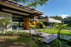 the house is surrounded by greenery and trees