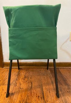 a green chair sitting on top of a hard wood floor