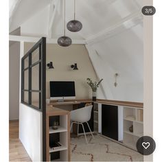 an attic office with white walls and wooden floors