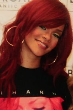 a woman with red hair and hoop earrings