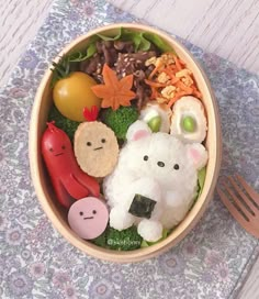 a wooden bowl filled with different types of food on top of a table next to a fork