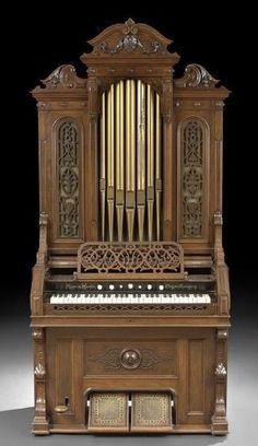 an old wooden organ sitting on top of a table