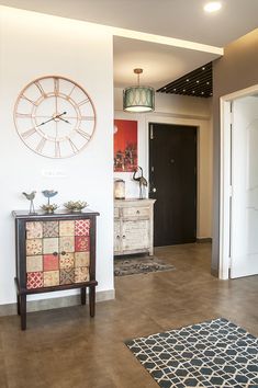 a living room with a large clock on the wall