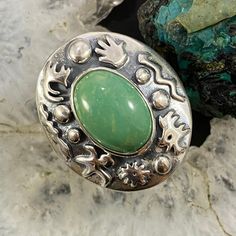 Beautiful And Eye Dazzling Carolyn Pollack Vintage Southwestern Style Sterling Silver Oval Green Turquoise Cabochon Set In A Smooth Bezel Decorated Petroglyph Ring. The Wide Border Pops With A Variety Of Petroglyph Symbols And The Rope Split Shank Gives It A Perfect Southwester Feel. This Design Has An Oxidized Finish With Beautiful Polished Accents. ** Stone Matrix And Shades May Vary. ** ** If Oxidation Or Tarnish Darkens The Piece Over Time, Use A Polishing Cloth To Restore To Desired Finish. ** Size 8 Length 1 1/8" Weighs 13.8 Grams (Cprn39s48) Silver Oval Turquoise Ring With Concho, Silver Oval Turquoise Ring With Concho Detail, Southwestern Style, Split Shank, Green Turquoise, Womens Jewelry Rings, Matrix, Ring Size, Women Jewelry