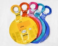 six assorted colored plastic cutting discs with labels on each side and the words new york printed on them