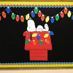 a bulletin board decorated with christmas lights and snoopy dogs sitting on top of a red car