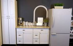 a white refrigerator freezer sitting inside of a kitchen next to a counter top oven