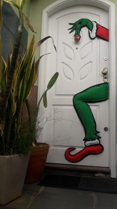 a door decorated with an elf's leg painted on it