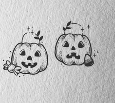 two pumpkins with faces drawn on paper