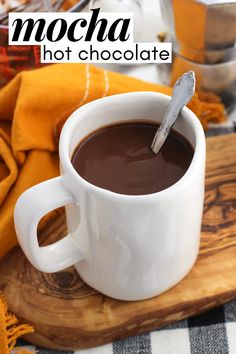 a cup of hot chocolate with a spoon in it